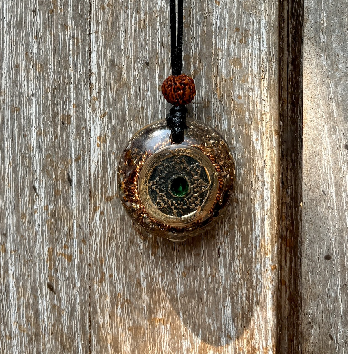 Bali Coin Tensioning Pendant gold mandala coin green stone copper border dark matrix rudraksha bead black cord orgonite sacred Balinese stones Batuan Bali