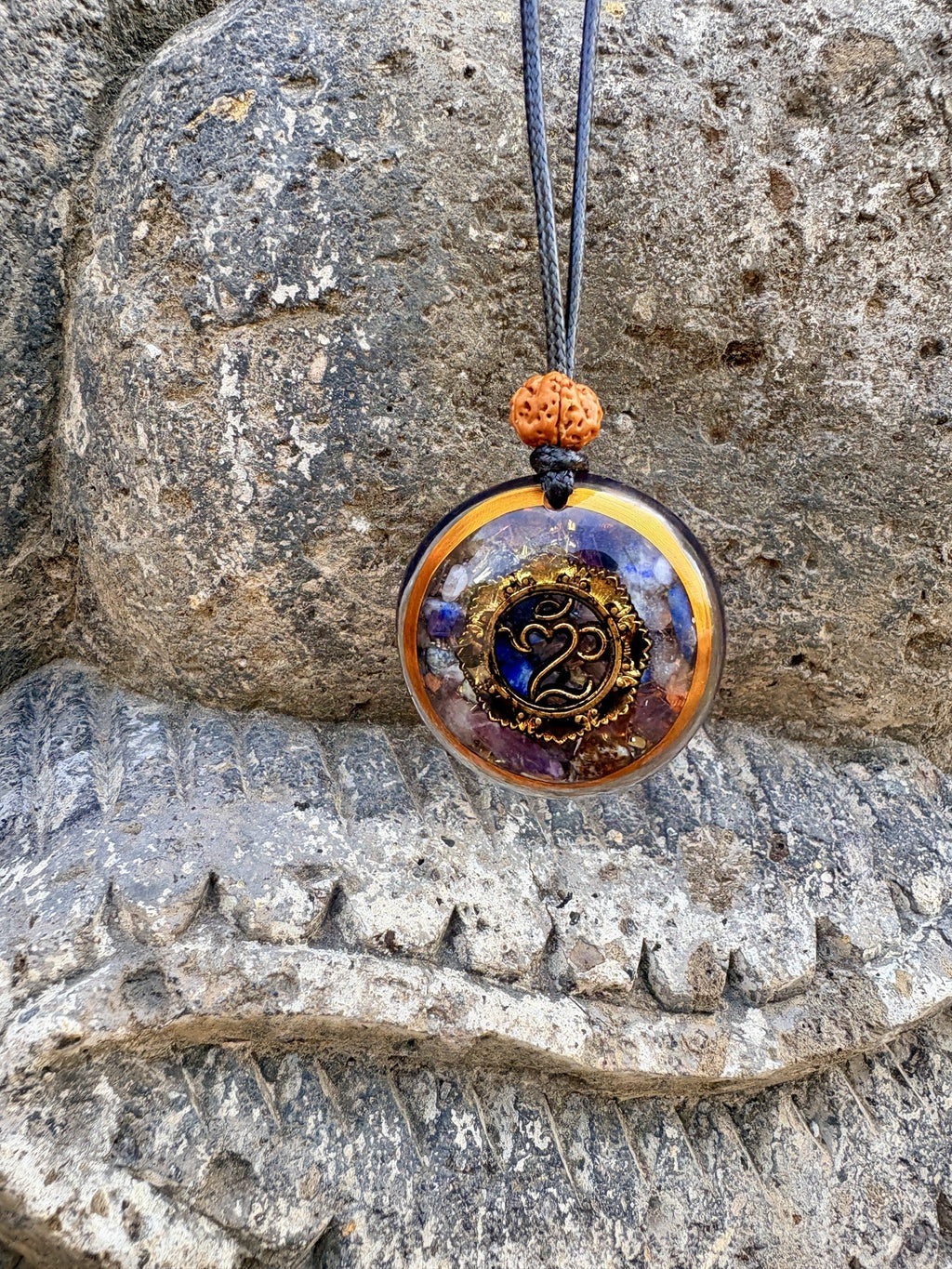 Bali Omkara Pendant front gold Om symbol disc lapis lazuli amethyst chakra stone matrix gold ring border rudraksha bail dark cord