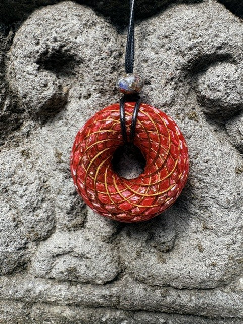 Large Red Jasper Torus Pendant copper spiral winding deep crimson red resin 48mm black braided cord mixed-stone bail bead Balinese stone wall Batuan Bali front view