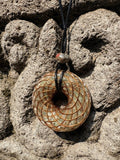 Large Green Aventurine Torus Pendant copper spiral winding warm golden green translucent resin 48mm black braided cord mixed-stone bail bead Balinese stone wall Batuan Bali front view