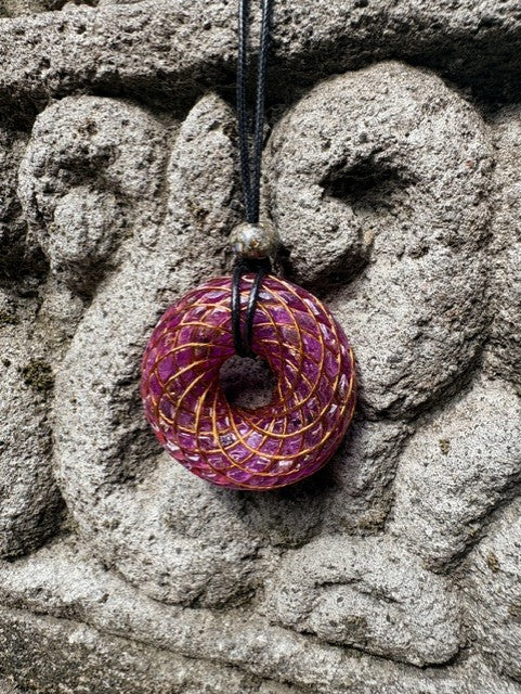 Large Purple Amethyst Torus Pendant copper spiral winding deep violet purple resin 48mm black braided cord mixed-stone bail bead Balinese stone wall Batuan Bali front view