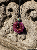 Small Purple Amethyst Torus Pendant copper spiral winding vivid magenta violet resin 33mm black braided cord mixed-stone bail bead Balinese stone wall Batuan Bali close-up