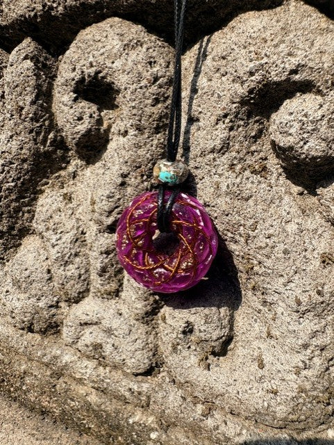 Small Purple Amethyst Torus Pendant copper spiral winding vivid magenta violet resin 33mm black braided cord mixed-stone bail bead Balinese stone wall Batuan Bali close-up