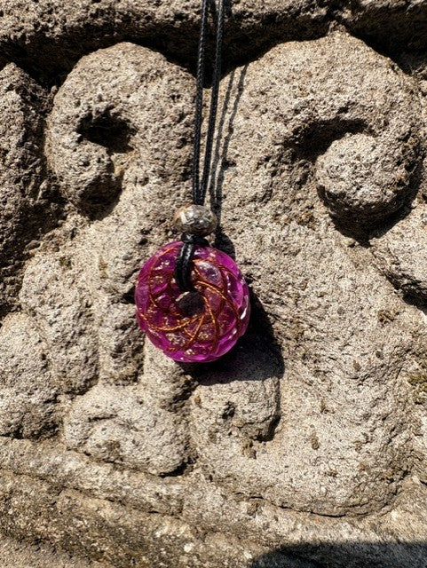 Small Purple Amethyst Torus Pendant copper spiral winding vivid magenta violet resin 33mm black braided cord mixed-stone bail bead Balinese stone wall Batuan Bali front view