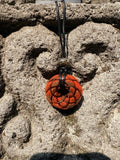 Small Red Jasper Torus Pendant copper spiral winding deep burnt orange red resin 33mm black braided cord stone bail bead Balinese stone wall Batuan Bali front view