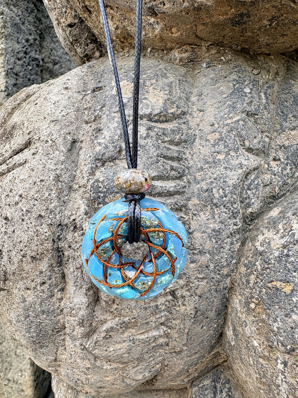Small Turquoise Torus Pendant copper Celtic knot crossover winding vivid sky blue turquoise resin gold leaf flecks 33mm black braided cord mixed-stone bail bead carved Balinese stone deity Batuan Bali front view