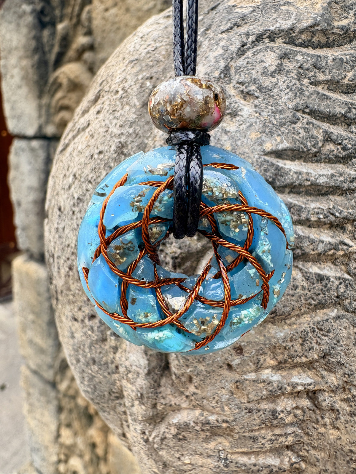 Turquoise Torus Pendant close-up copper torus knot coil Turquoise orgonite mixed-stone bail bead black braided cord Batuan Bali