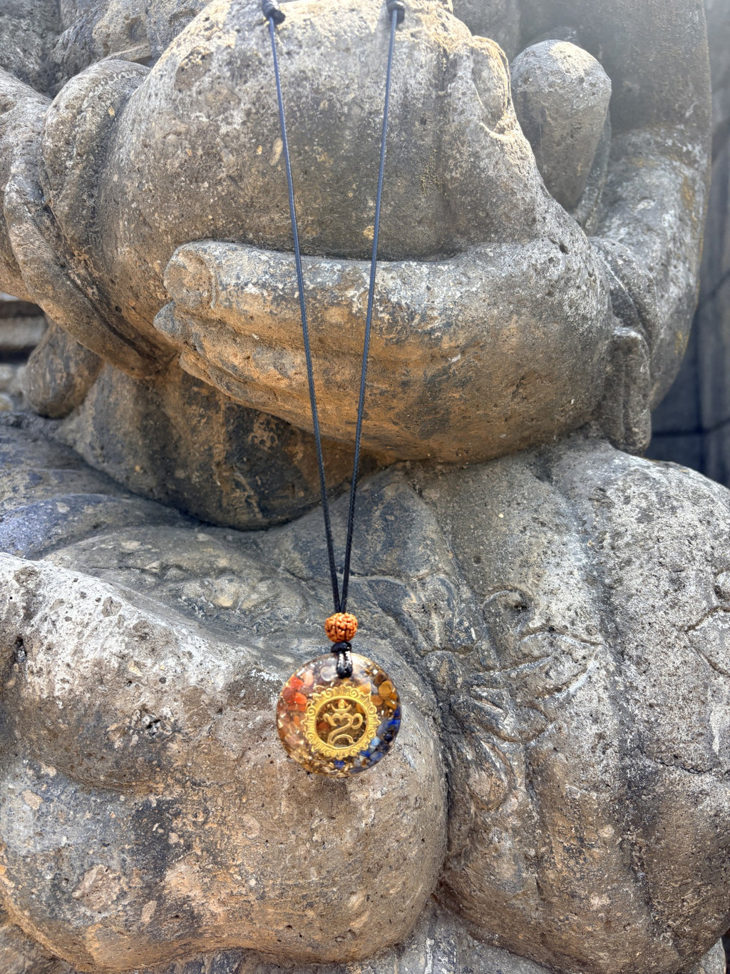 Bali Umkara Pendant gold Om symbol chakra stones rudraksha bead black cord orgonite clear resin Buddha hands Batuan Bali