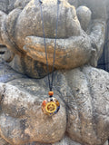 Bali Umkara Pendant gold Om symbol chakra stones rudraksha bead black cord orgonite clear resin Buddha hands Batuan Bali